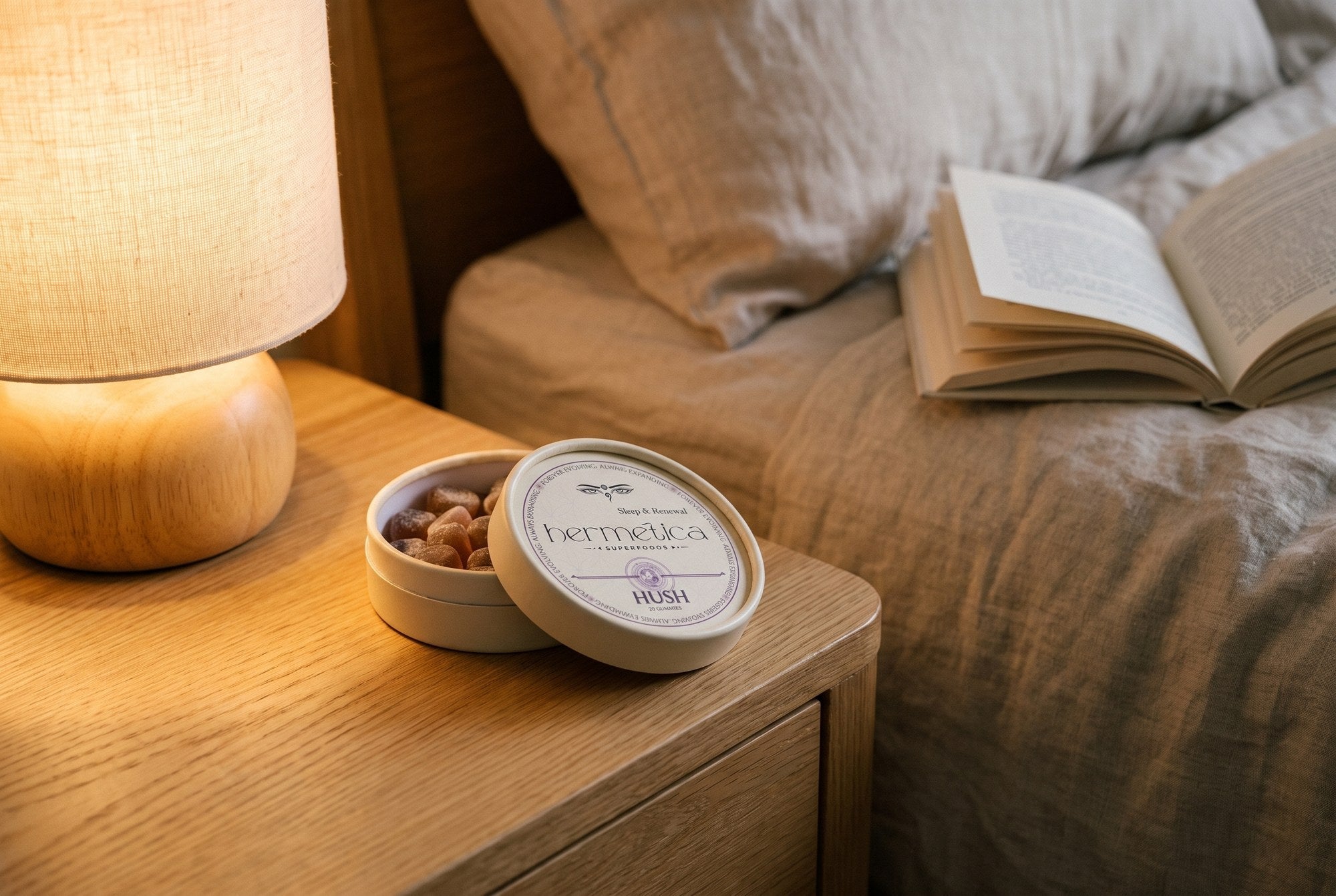 Hush sleep gummies tin on a bedside table