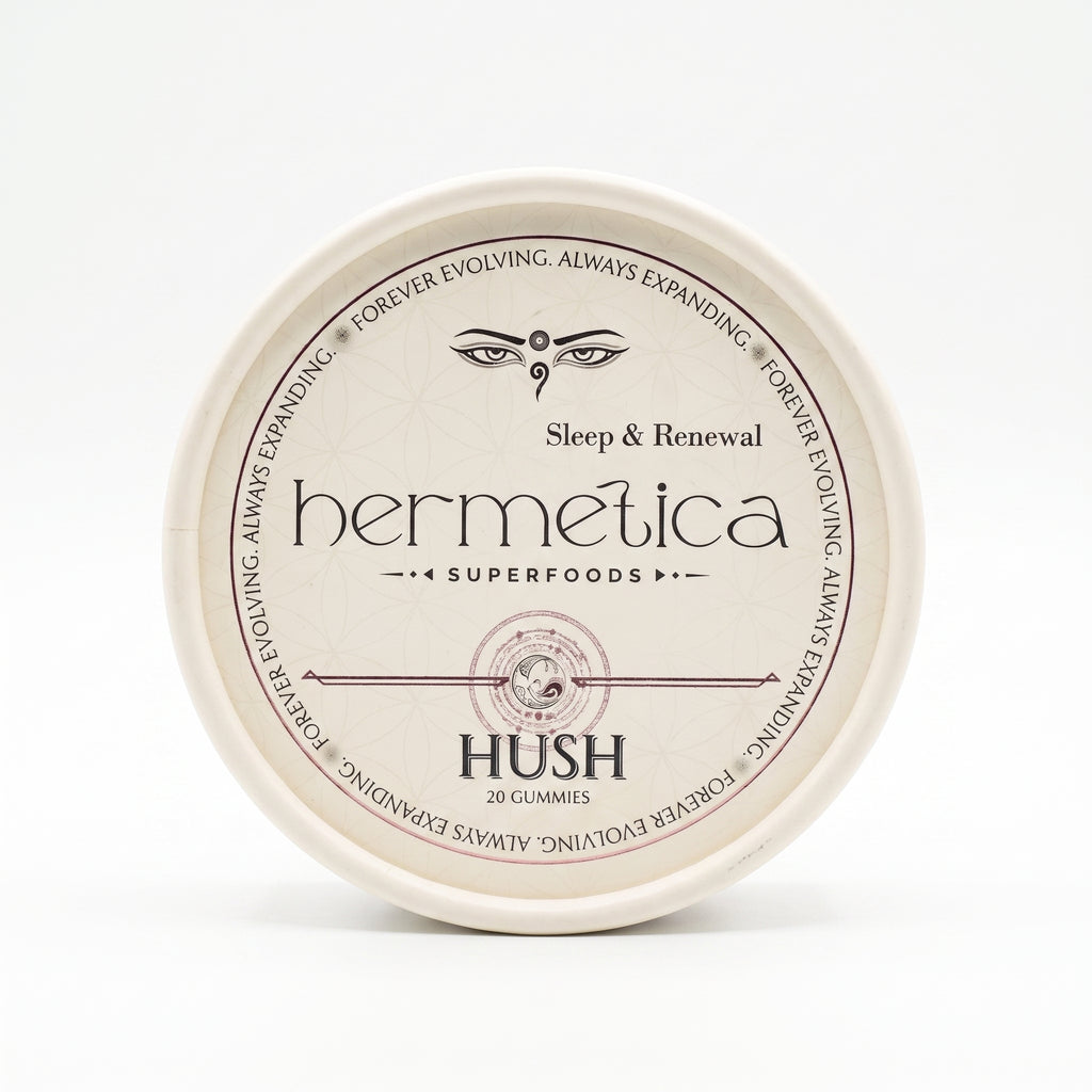 Overhead shot of a round Hermetica Hush low-dose melatonin sleep gummies container on a white background.