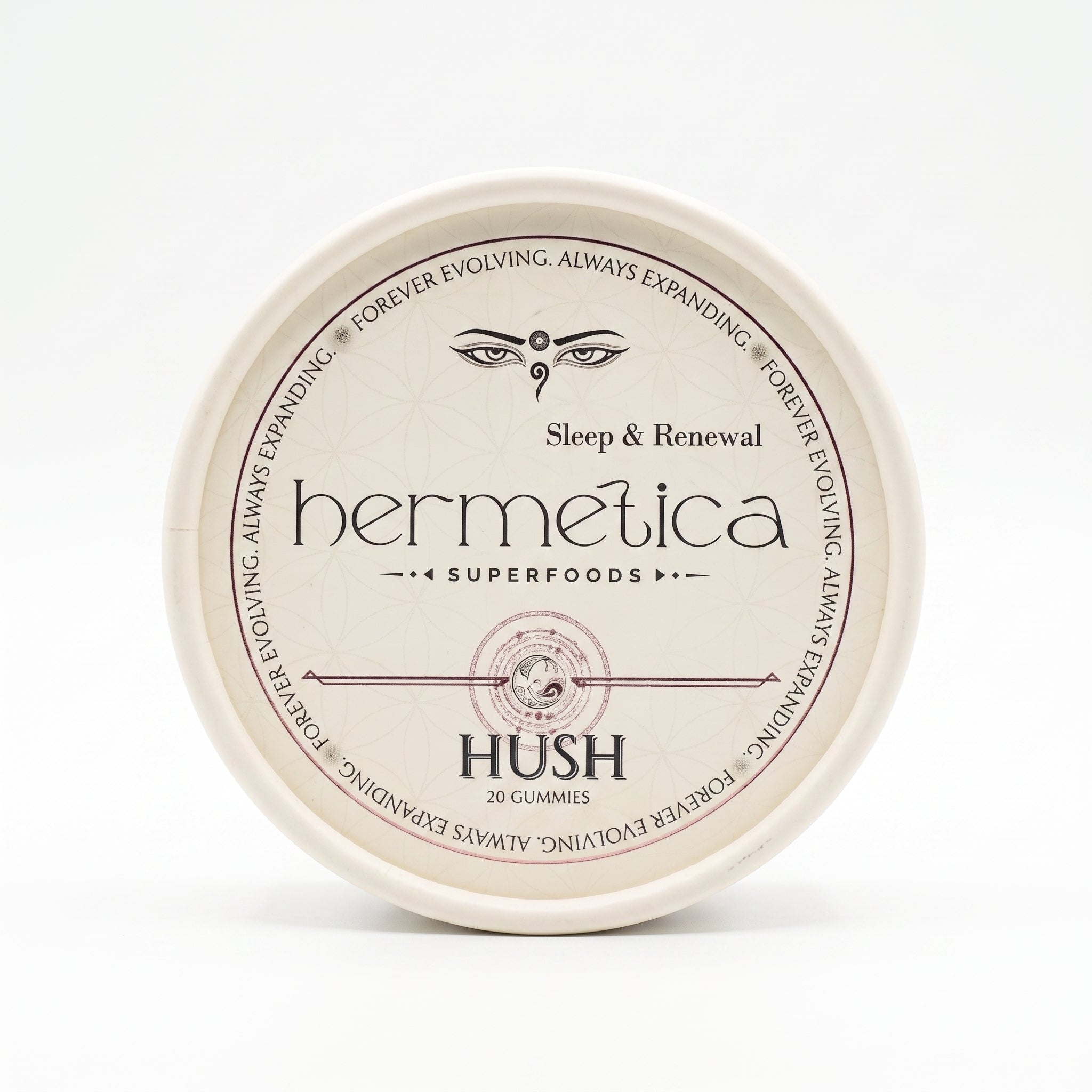 Overhead shot of a round Hermetica Hush low-dose melatonin sleep gummies container on a white background.