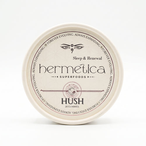 Overhead shot of a round Hermetica Hush low-dose melatonin sleep gummies container on a white background.