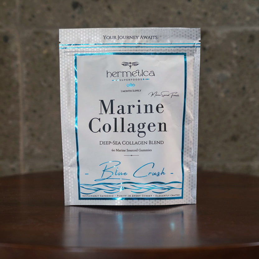 Blue Crush Marine Collagen pouch on marble with blue-violet collagen gummies spilled in front