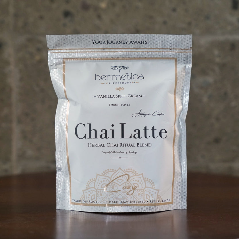 Cozy Adaptogenic Chai pouch on a side table by an armchair with a knit blanket