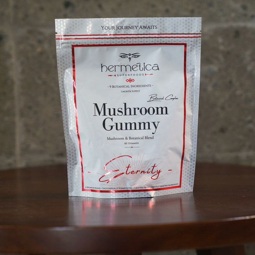 Eternity Mushroom Gummies pouch on an oak desk with a journal and tea in morning light