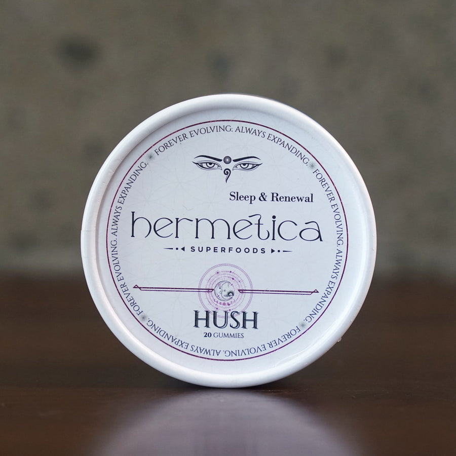 Hush Sleep Gummies tin photographed straight on, showing the full Sleep and Renewal label with lavender