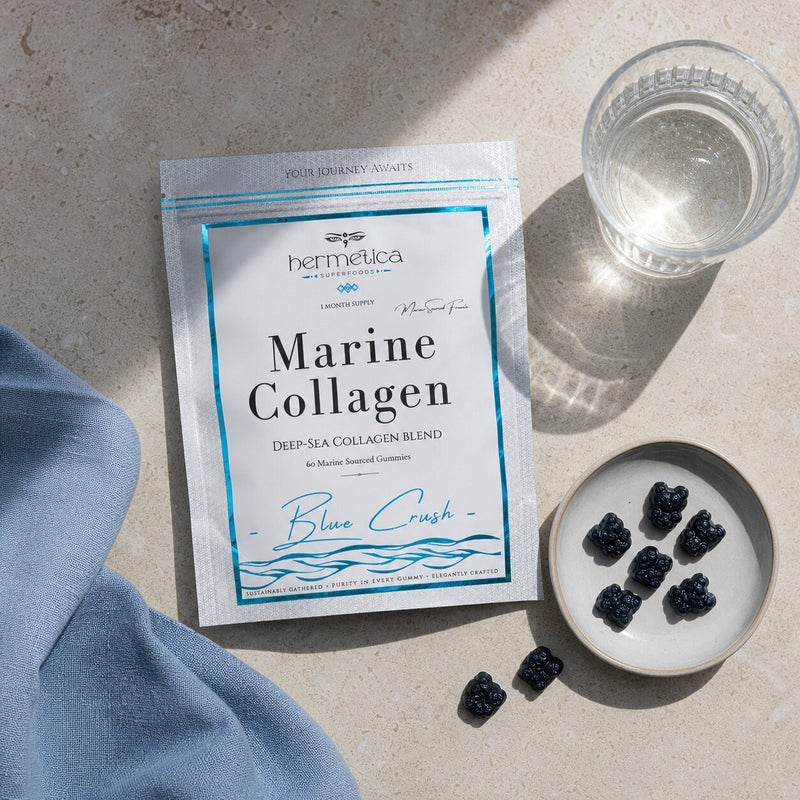 Blue Crush Marine Collagen pouch in an overhead pale-stone ritual with blue linen and gummies