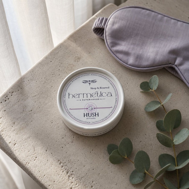 Hush Sleep Gummies tin beside lavender in soft dawn light