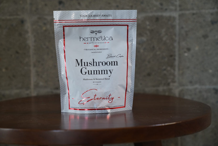 Eternity Mushroom Gummies pouch on a wooden shelf beside dried mushrooms and reishi