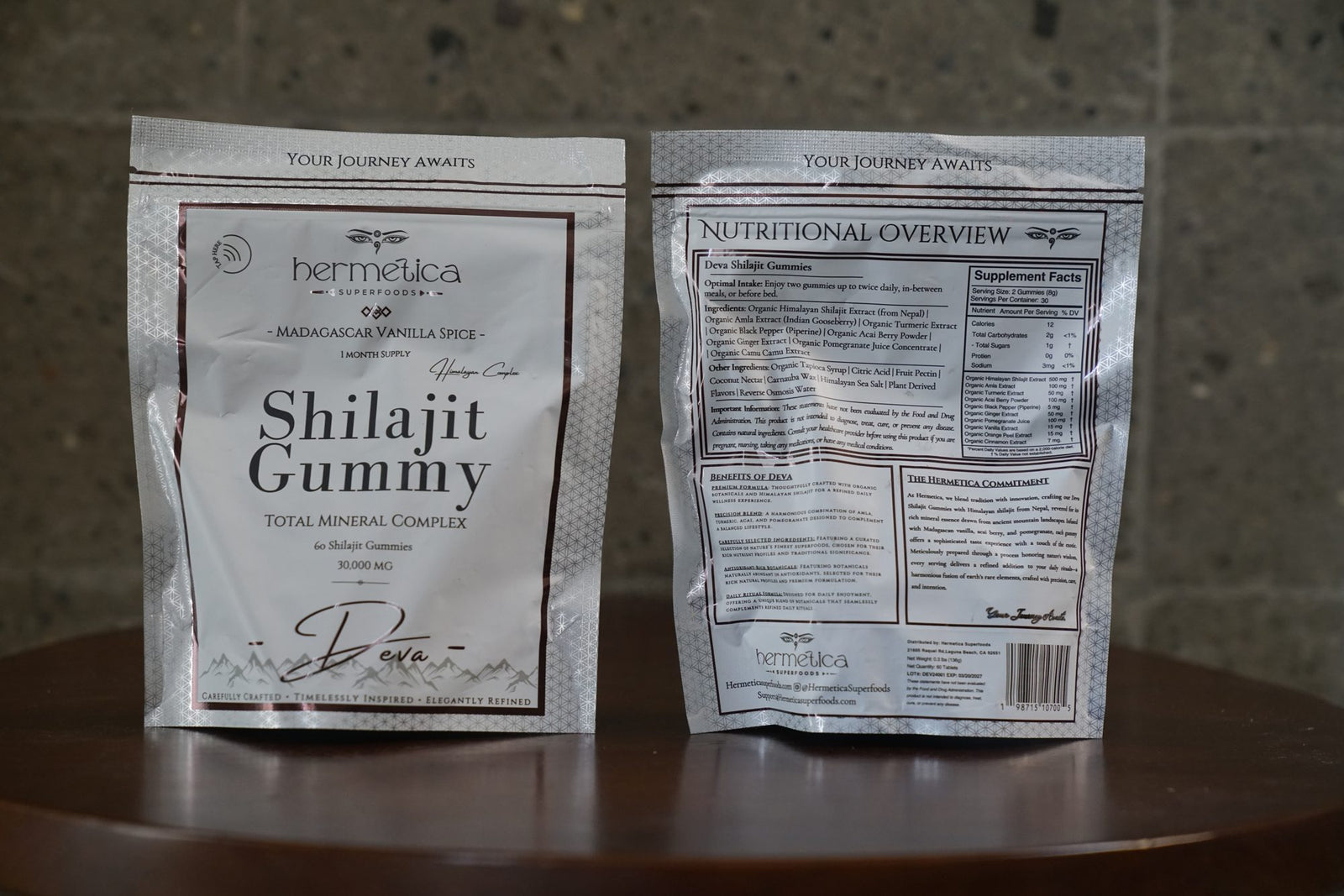 Deva Shilajit Gummies pouches photographed front and back on a wood stool