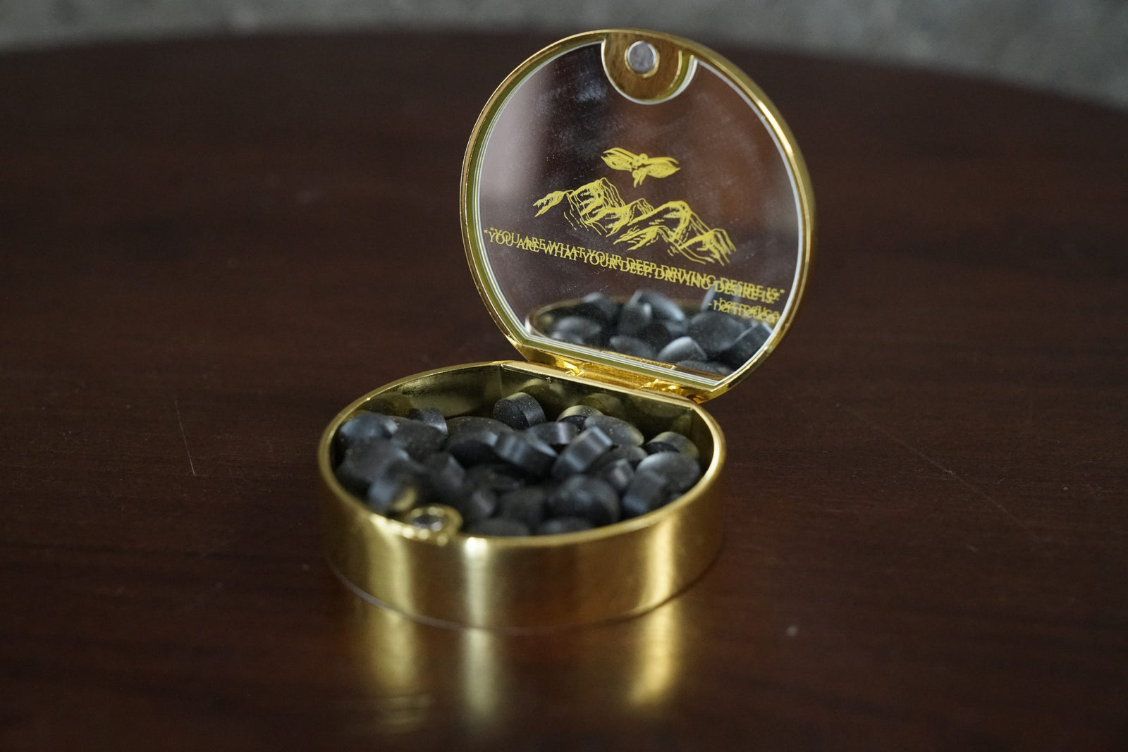 Meru gold tin open showing tablets and its mirrored lid