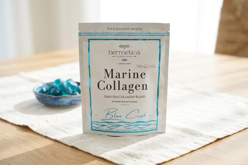 Blue Crush Marine Collagen pouch on a light oak table in morning light with eucalyptus and water