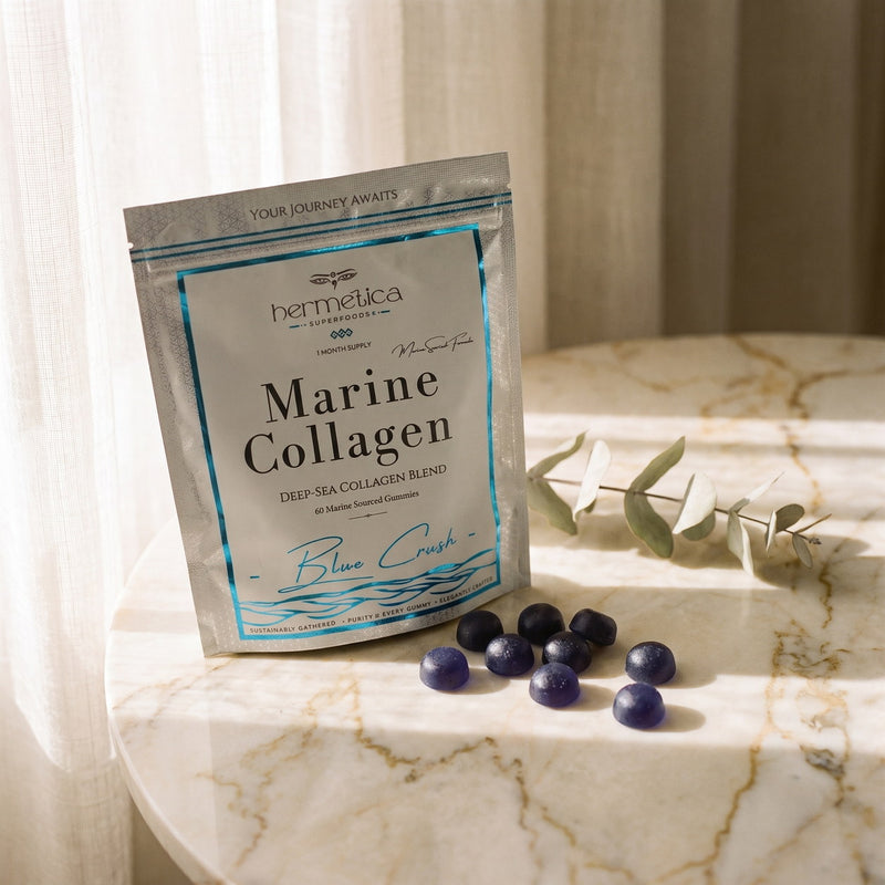 Blue Crush Marine Collagen pouch on marble with blue-violet collagen gummies spilled in front
