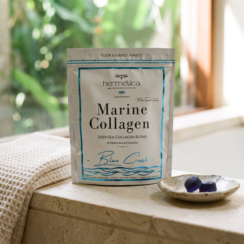 Blue Crush Marine Collagen pouch on a limestone vanity beside a folded towel and a dish of gummies