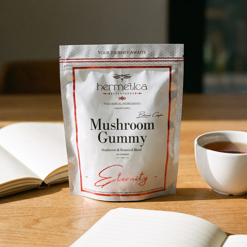 Eternity Mushroom Gummies pouch on an oak desk with a journal and tea in morning light