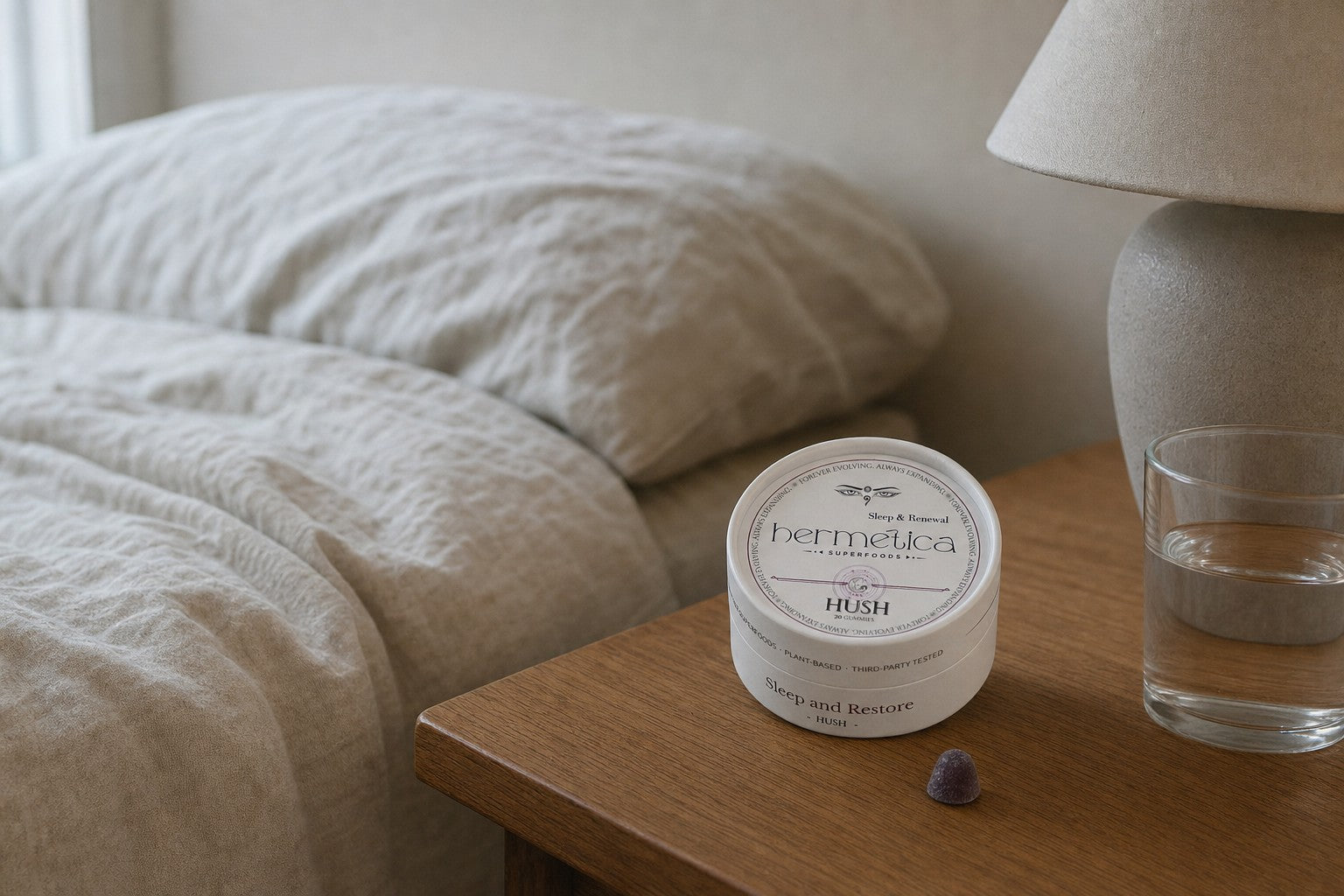 Hush Sleep Gummies tin on a bedside table at dusk