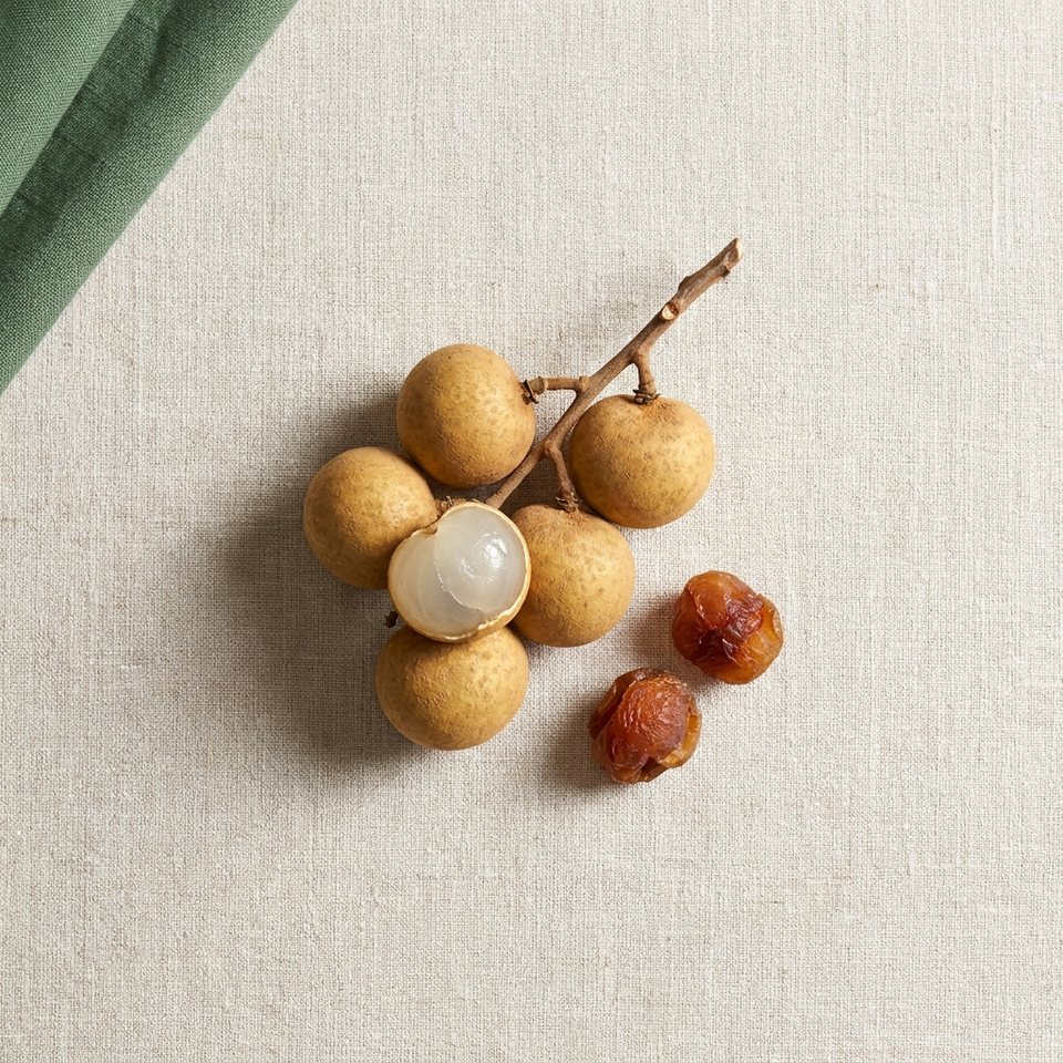 Longan fruits, one peeled, with dried longan