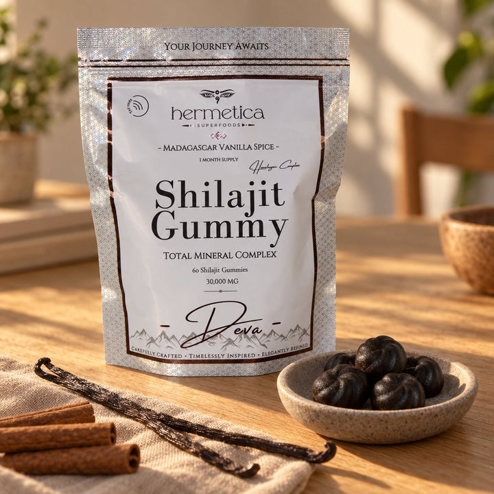 Deva Shilajit Gummies pouch on warm sandstone in golden light with mineral stones