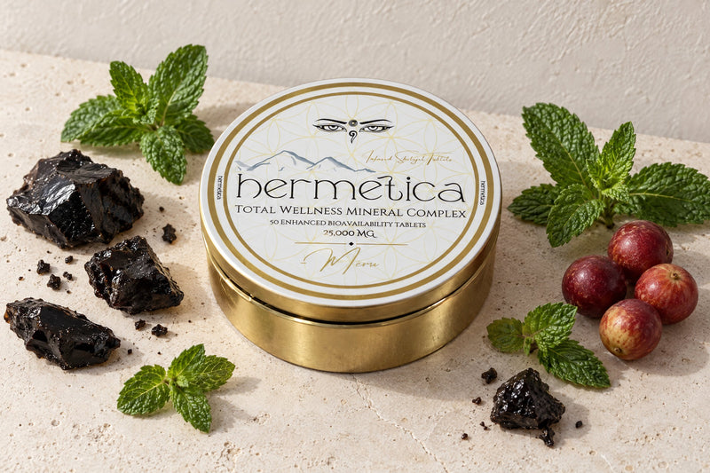Meru tin on pale stone, wide view, with shilajit resin, peppermint and camu camu berries